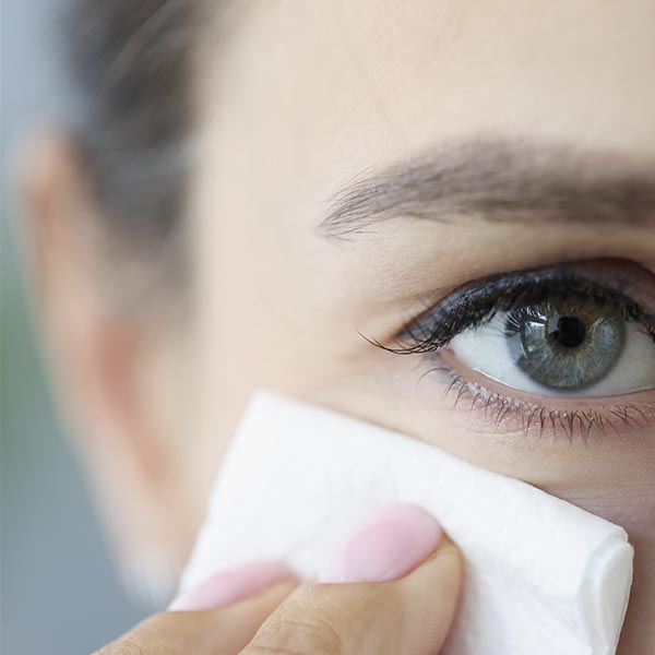 Woman using wipes to clean eyelids