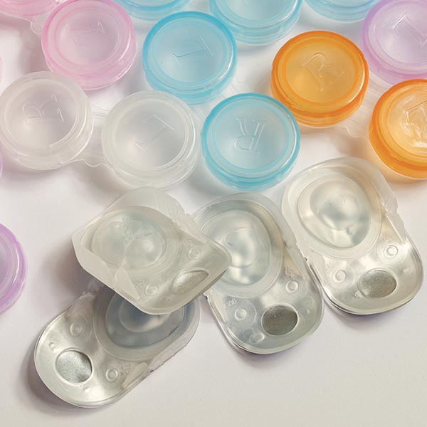 Packages of daily contacts and multicolored contact cases