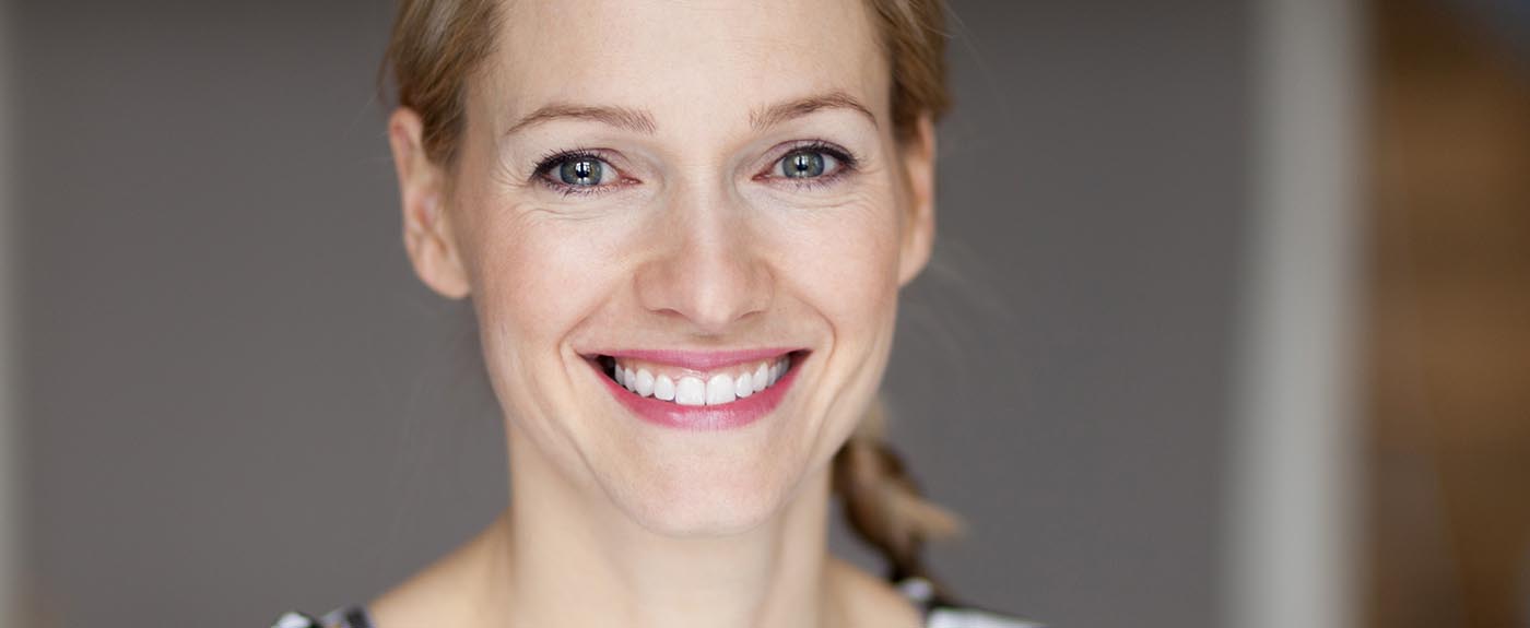 Close up Of A Smiling blond woman wearing a striped shirt